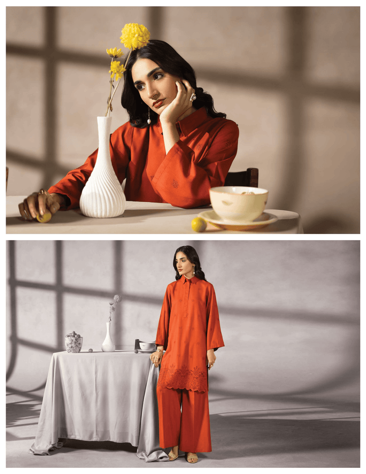 Model in RANGREZA EA-50-3805 orange pakistani two piece suit styled with minimal accessories, showcasing daily wear fashion in a modern setting.