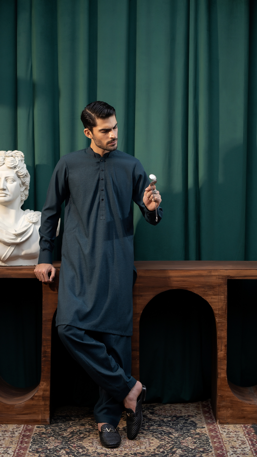 Full view of Men By Rangreza MA-05-55 dark blue kurta pajama set styled with traditional footwear in a sophisticated setting.