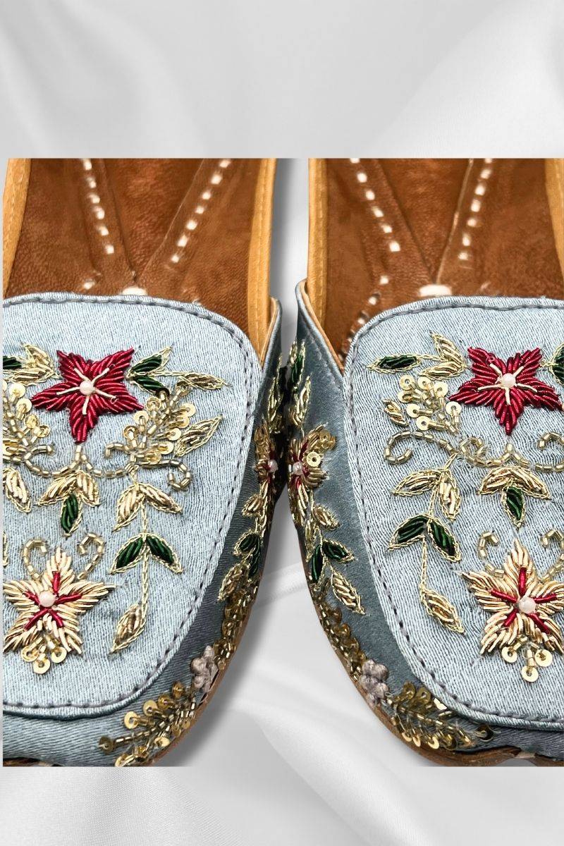 Close-up of Bahaar IceBlue Jutti showing detailed gold embroidery and red floral 3D embellishments on traditional Pakistani khussa shoes.