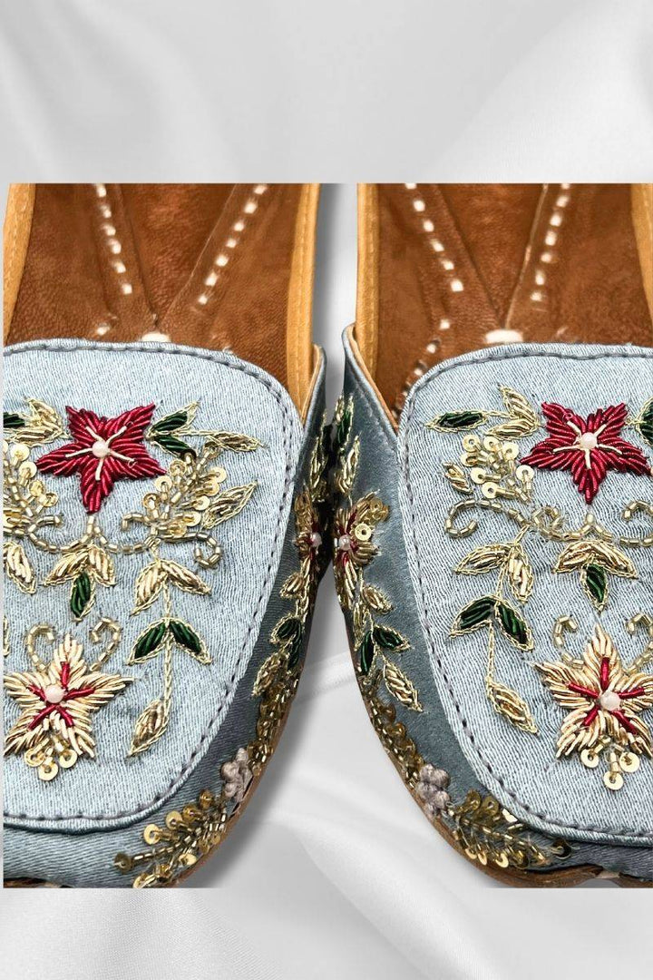Close-up of Bahaar IceBlue Jutti showing detailed gold embroidery and red floral 3D embellishments on traditional Pakistani khussa shoes.
