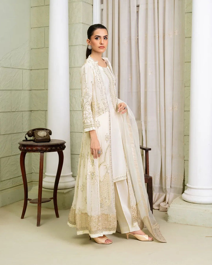 Side profile of ivory Pakistan gown dress woman with gold embroidery and sheer dupatta, perfect for formal occasions.