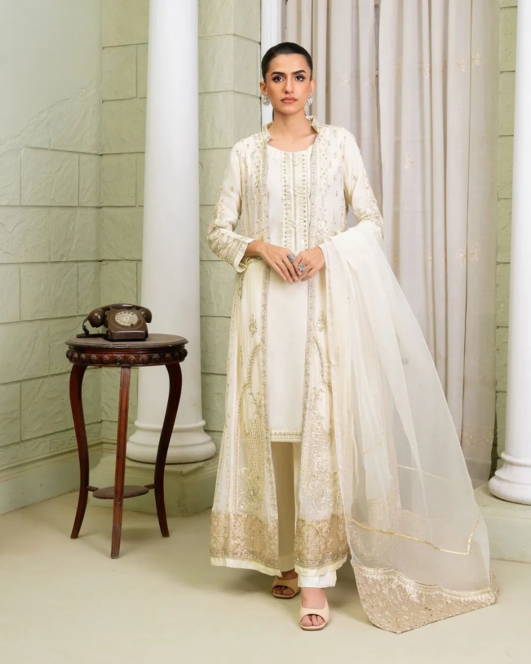 Front view of ivory Pakistan gown dress woman with embroidered shirt pants and dupatta, ideal for elegant events.