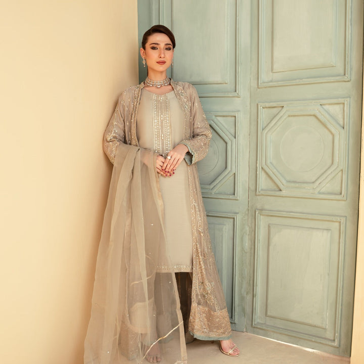 Taupe-toned Pakistan gown dress woman with sheer dupatta and intricate embroidery, elegant shirt pants and dupatta set.