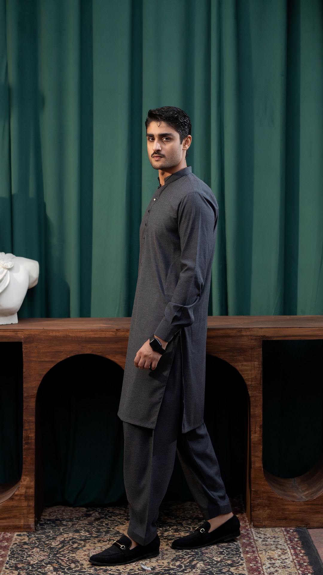 Side profile of a model in dark grey Rangreza kurta pajama MA-07-55, highlighting its tailored fit and ceremonial style.