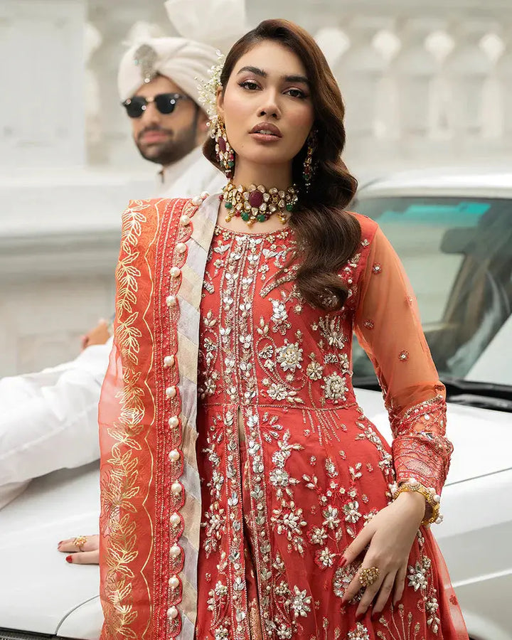 Close-up of AROOSH Wedding Wear AR-103-2200 showing intricate embroidery on the red peplum and organza dupatta. A luxurious choice for Pakistani wedding attire.