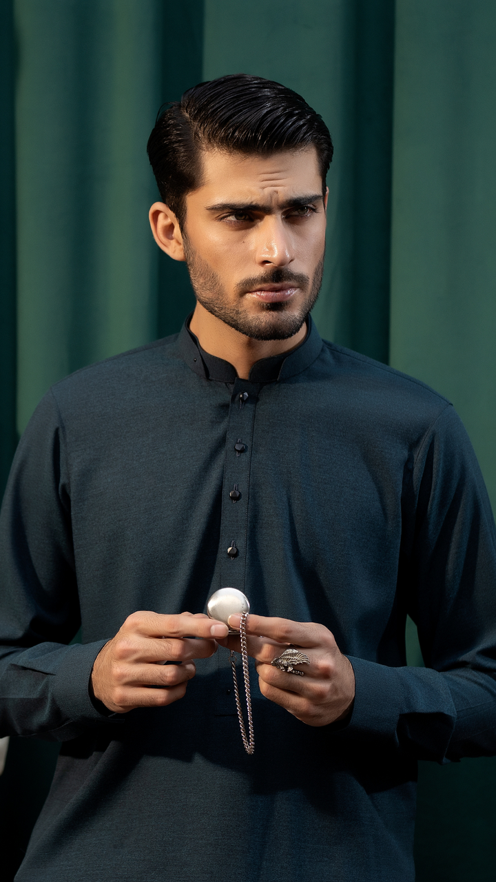 Model wearing Men By Rangreza MA-05-55 dark blue kurta, holding a pocket watch, highlighting traditional and modern fusion.