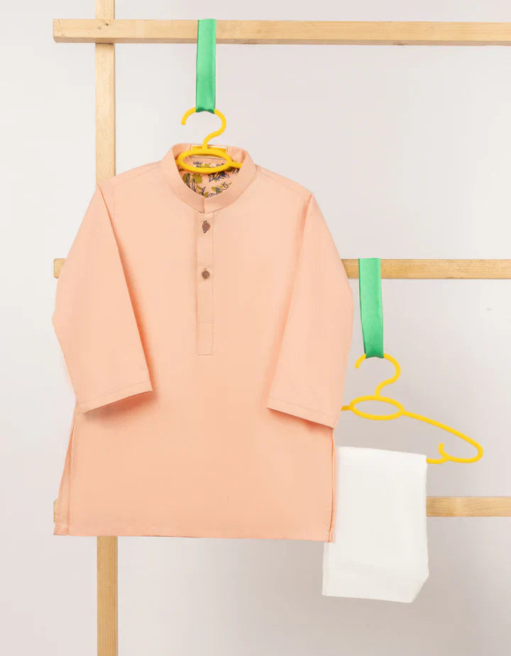 Peach Blended Kameez Shalwar for kids with a traditional collar and wooden buttons, paired with white bottoms. Ideal for cultural and festive wear.