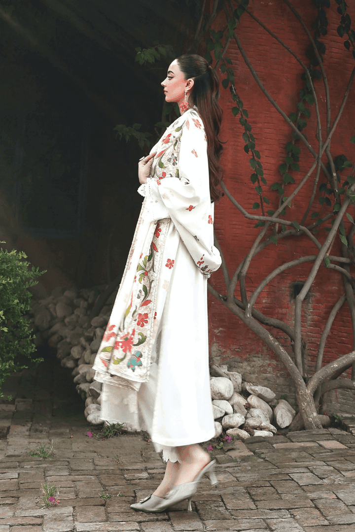Rangreza AL-1125 Pakistani suit side view showcasing intricate embroidery on white Dhanak shirt and vibrant floral printed wool shawl.