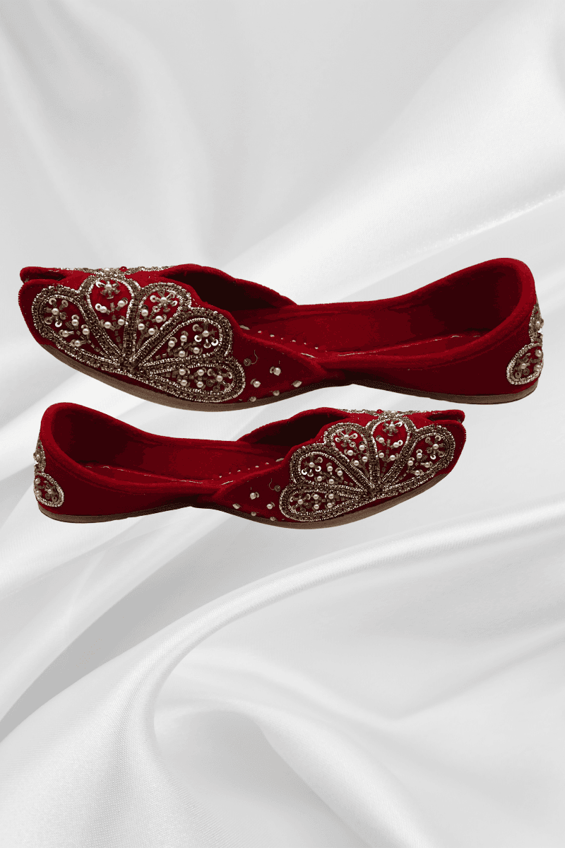 Side view of Naz Red Jutti - elegant velvet peep-toe flats featuring intricate gold scalloped embroidery, perfect for traditional occasions.