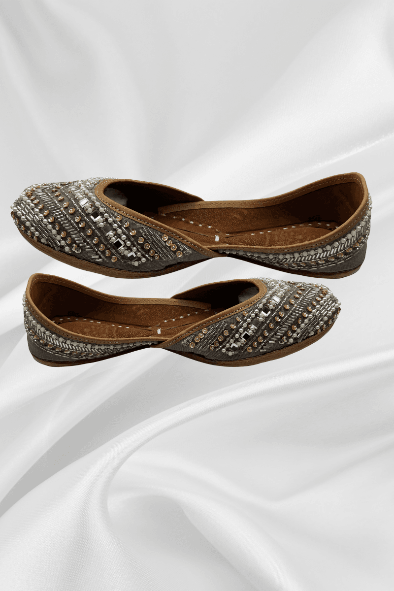 Side view of Naqshi Silver Jutti featuring detailed pearl and silver embellishments on velvet, showcasing traditional Pakistani khussa craftsmanship.