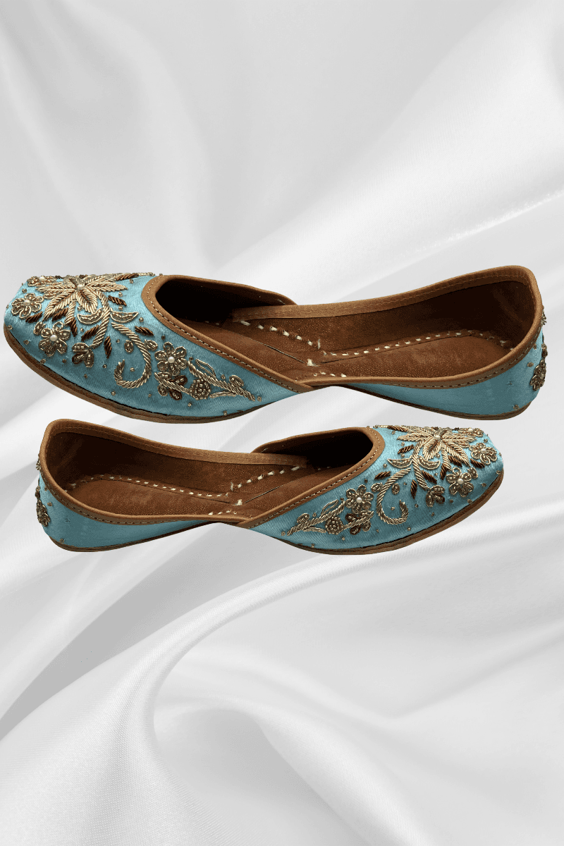 Side view of Sundas Sky Blue Jutti featuring detailed gold floral embroidery with pearls and crystals, perfect for bridal and ethnic outfits.