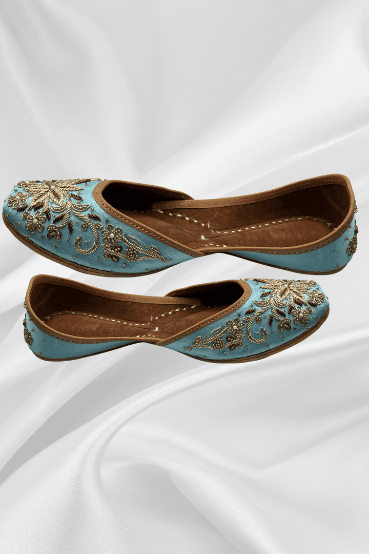 Side view of Sundas Sky Blue Jutti featuring detailed gold floral embroidery with pearls and crystals, perfect for bridal and ethnic outfits.