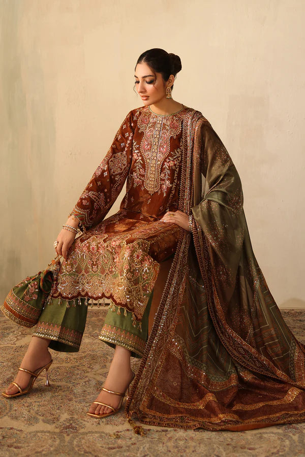 Seated woman in embroidered velvet outfit with dupatta