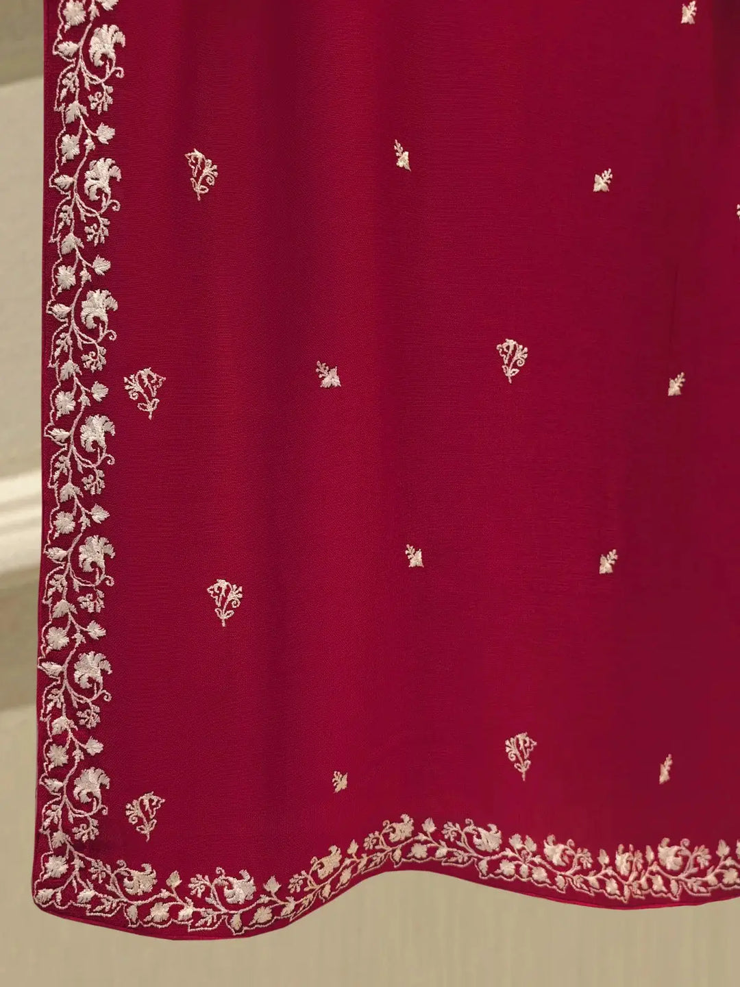 Lower hem of AGHA NOOR embroidered cotton shirt featuring fine white floral embroidery and border detailing.