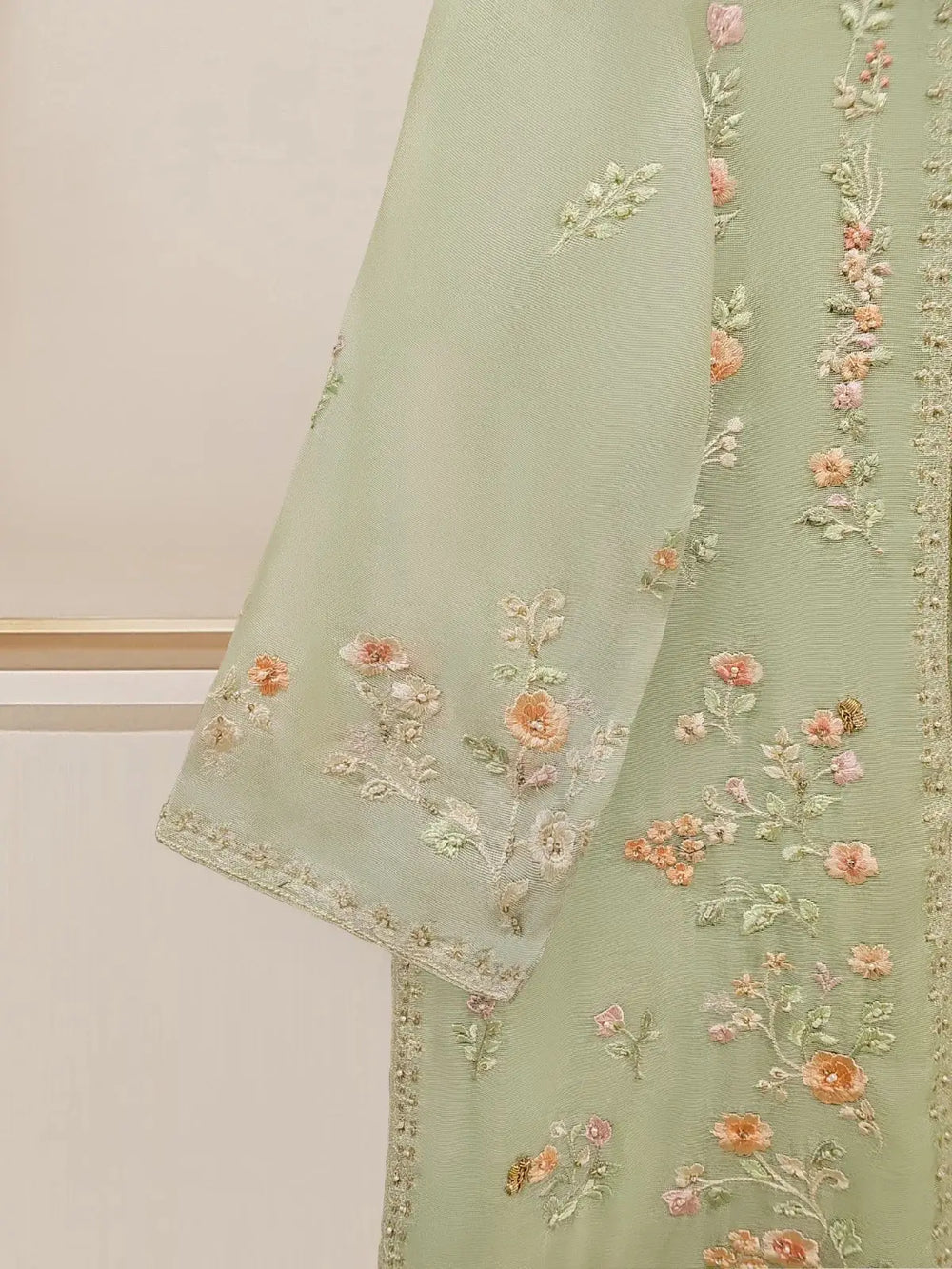 Close-up of floral embroidery on Agha Noor suit sleeve