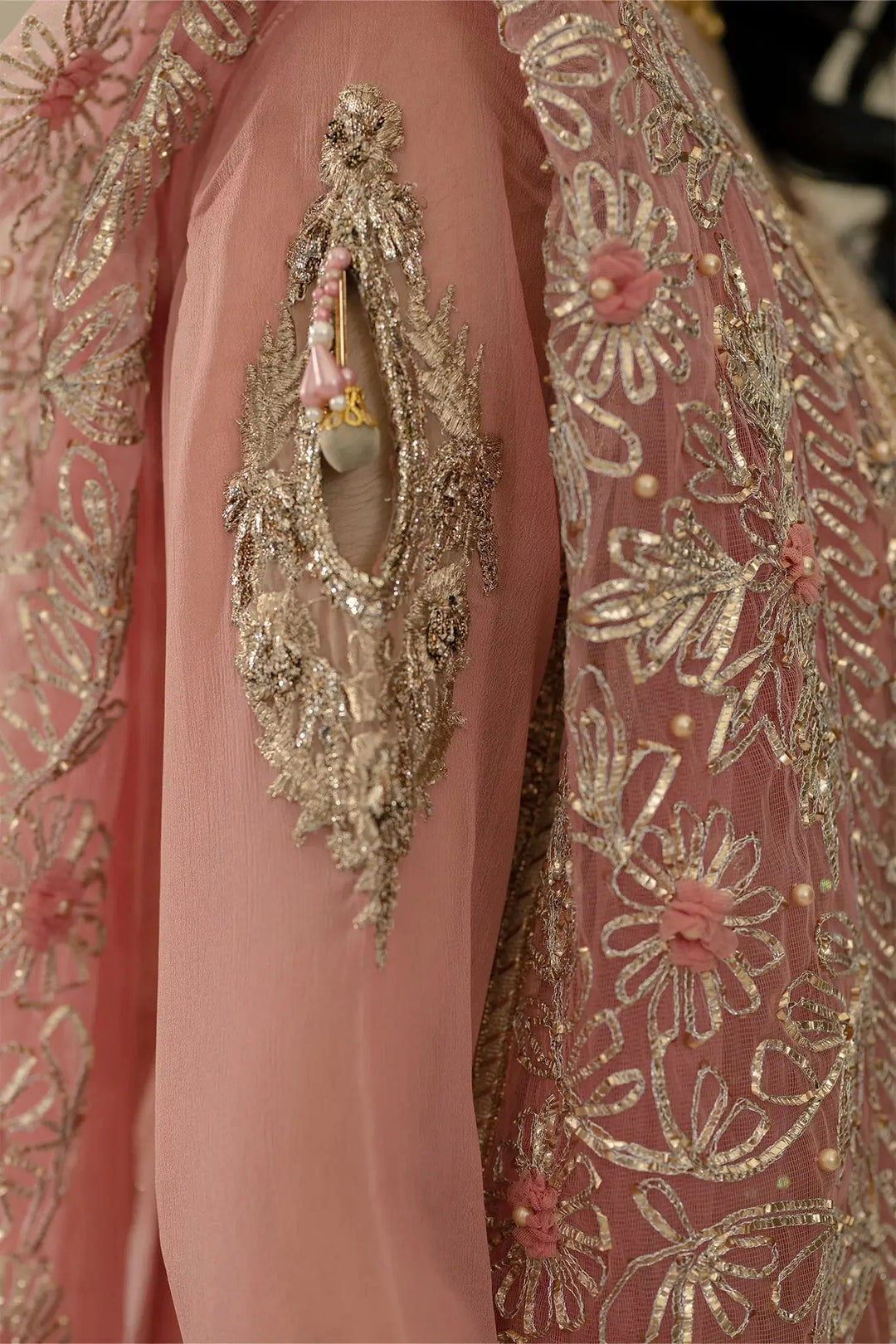 Sleeve embroidery close-up of KHUDA BAKSH M-109 Pink, showcasing floral patterns and delicate net fabric craftsmanship.
