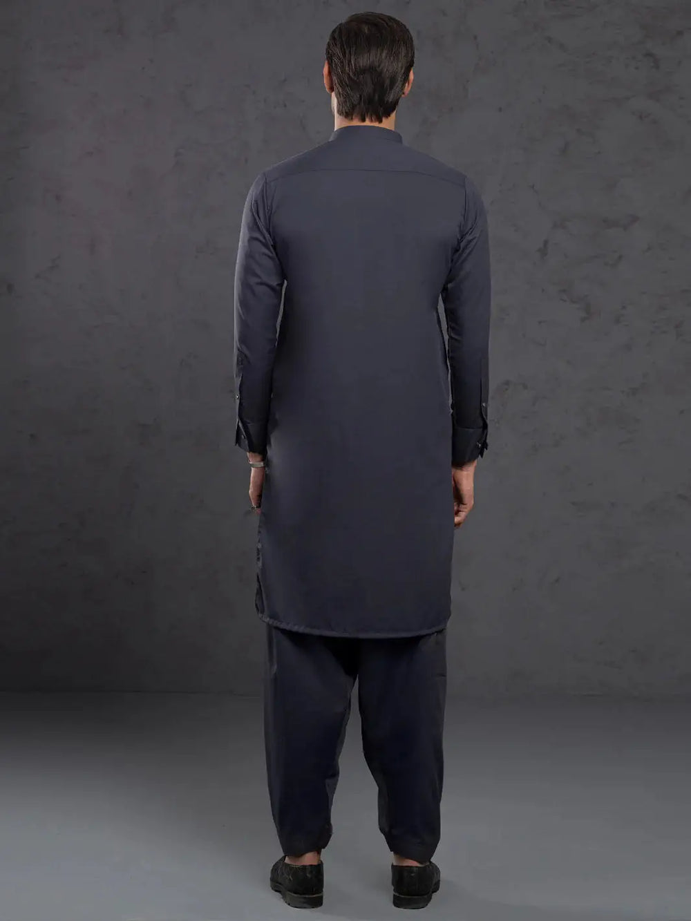 Back view of man in navy blue kurta with straight cut, long sleeves, and traditional design for men's clothing