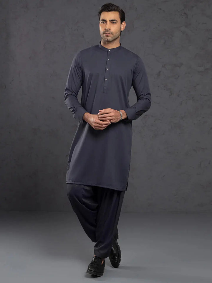 Man wearing navy blue kurta with mandarin collar and button placket, full sleeves, traditional attire for men
