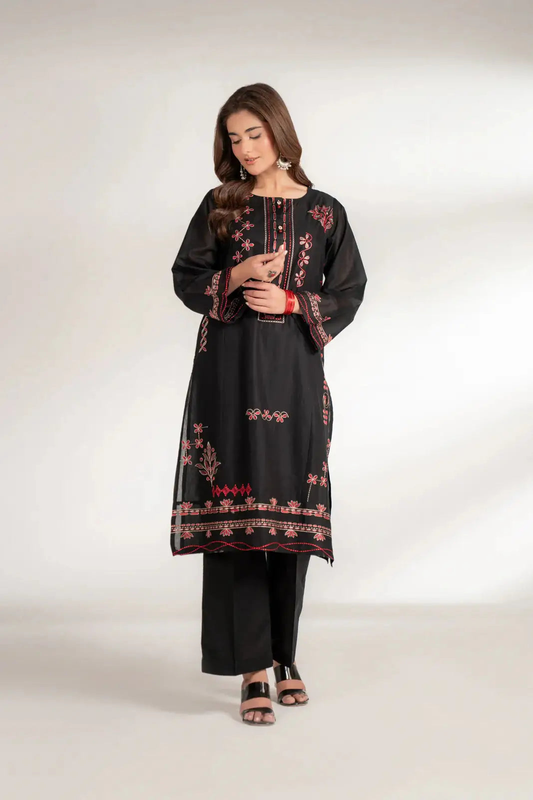 INARA Lawn Shirt - 1 Piece Pakistani Embroidered Shirt in black, featuring intricate red embroidery on front and hem, styled with black pants.