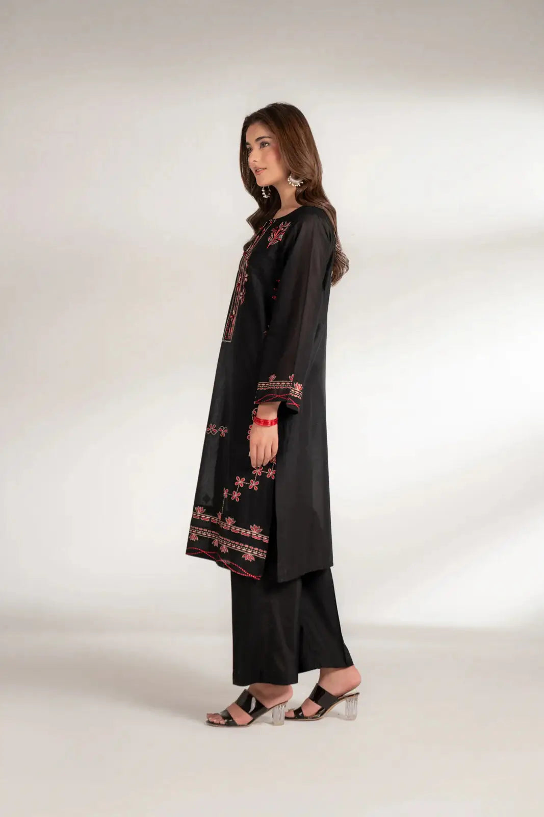 Side profile of INARA Lawn Shirt - Pakistani Embroidered Shirt in black, highlighting side slit and detailed embroidery on sleeves and hem.