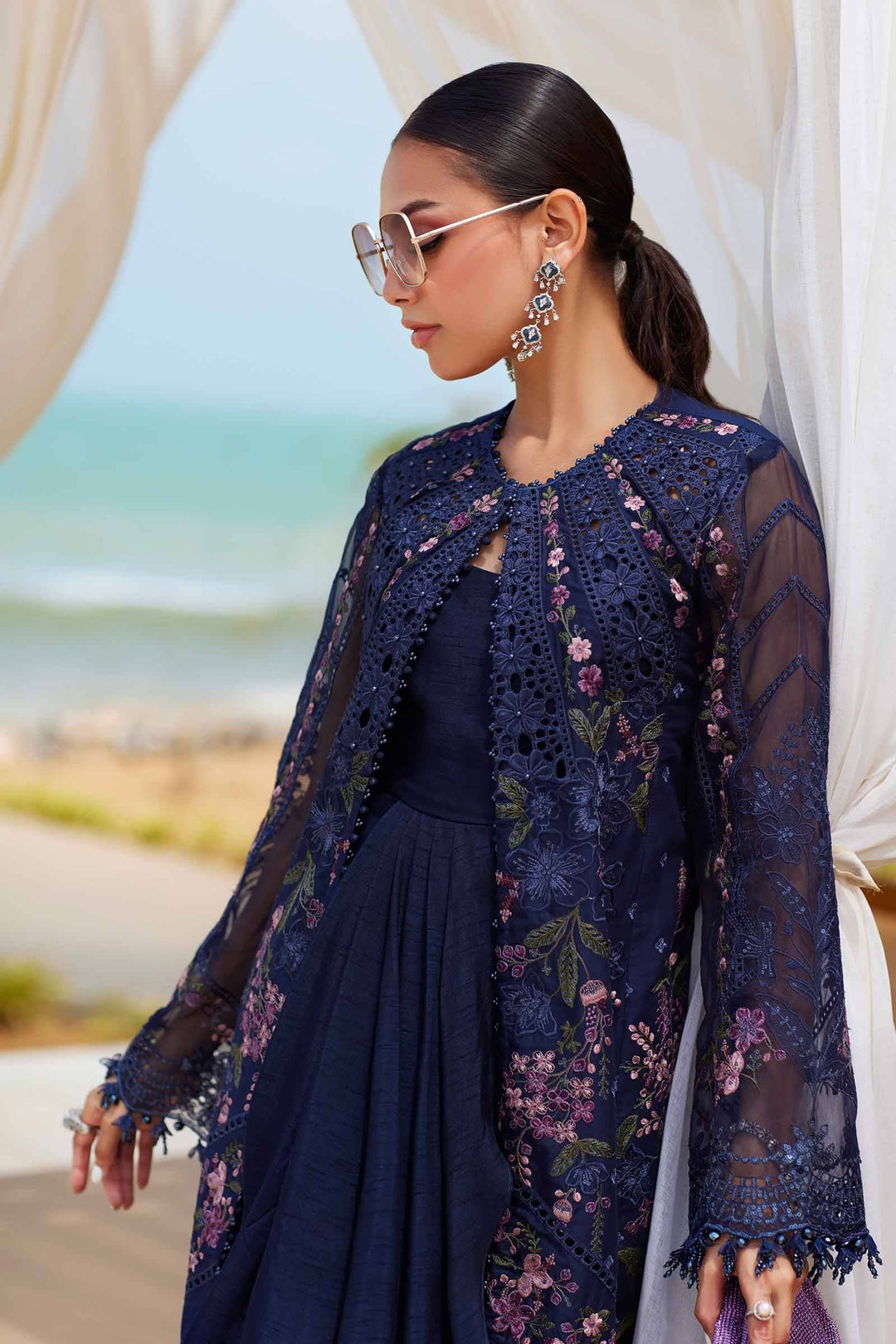 Model wearing AL-4311 navy embroidered jacket over lawn suit, showcasing sheer organza sleeves and floral detailing for luxury apparel styling.
