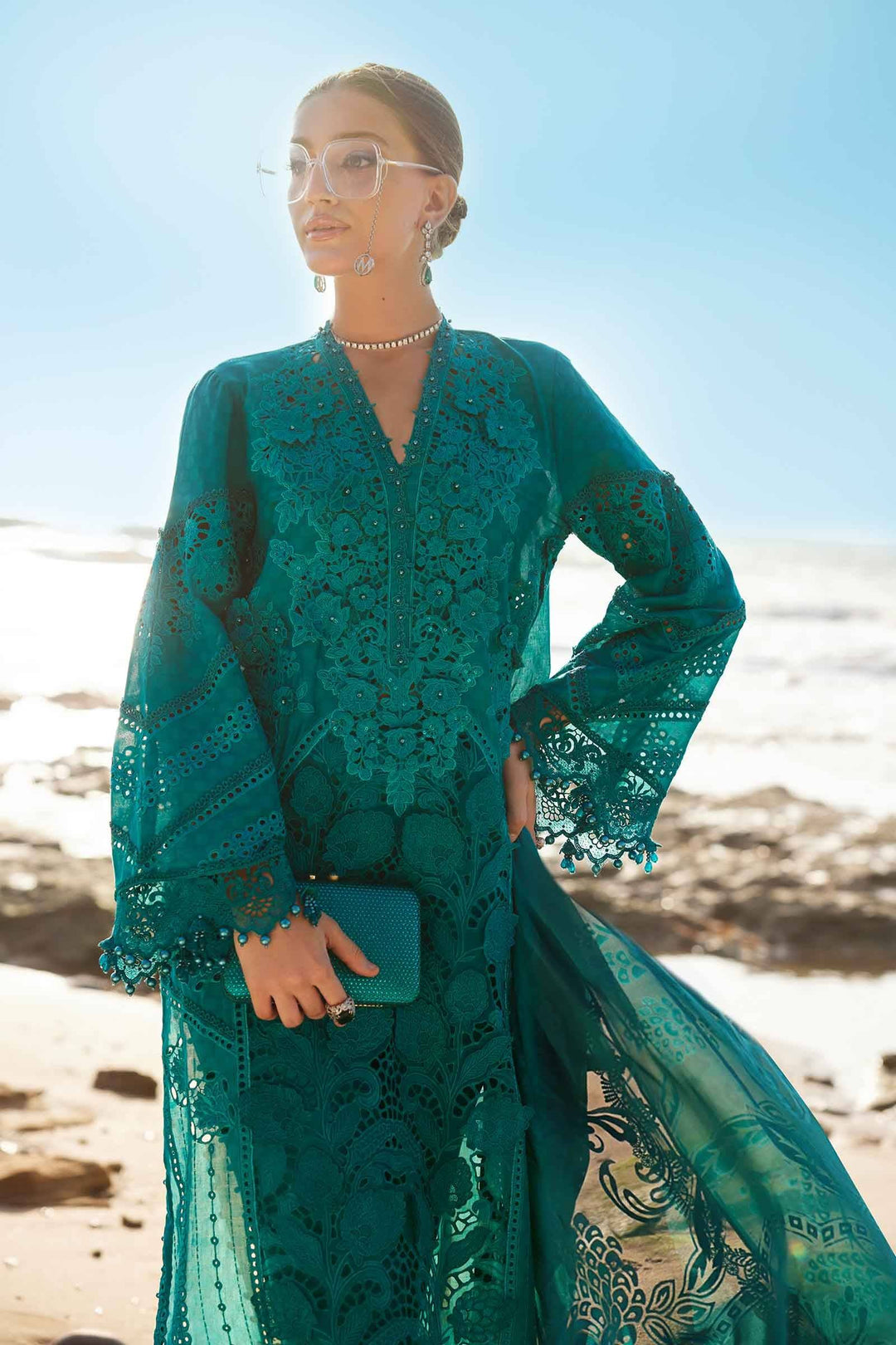 Model wearing AL-4310 sea green embroidered lawn suit with matching dupatta and clutch, ideal for festive and formal wear.