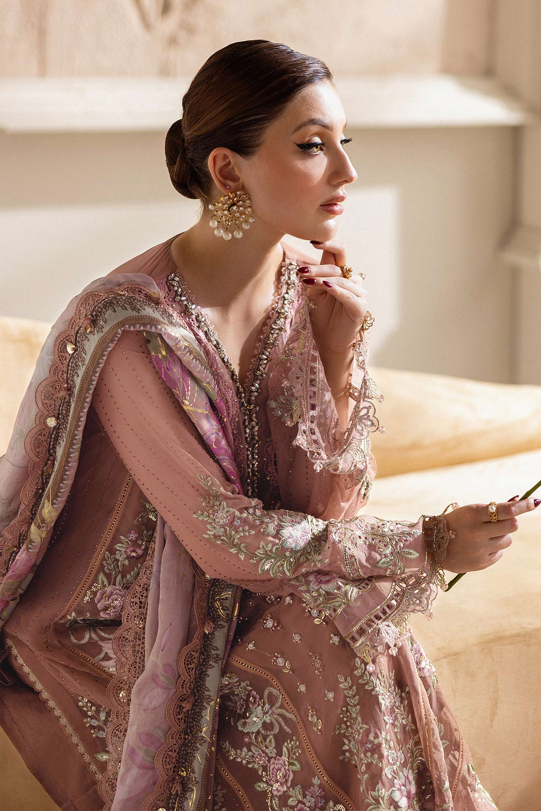 Side profile of model in MARIA.B MPC-25-105 luxury chiffon suit with hand embellishments and floral dupatta in soft pastel tones.