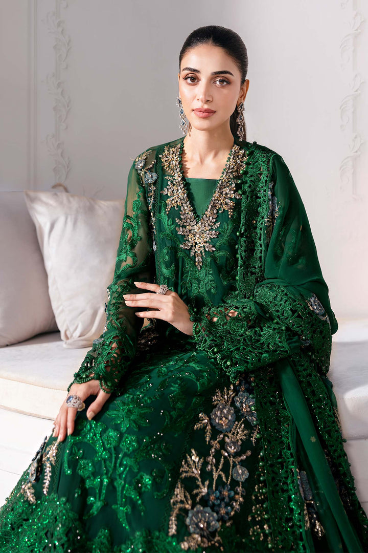 Elegant seated view of Luxury Embroidered Chiffon Suit AL-4230 showcasing floral motifs, silk undershirt, and detailed dupatta in deep green.