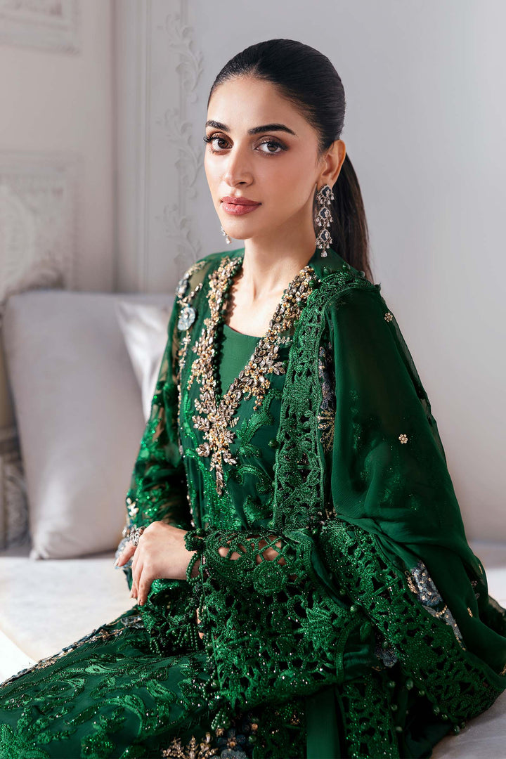 Side profile of model in AL-4230 green 3-piece chiffon suit highlighting 3D floral embroidery and lace detailing on sleeves and dupatta.