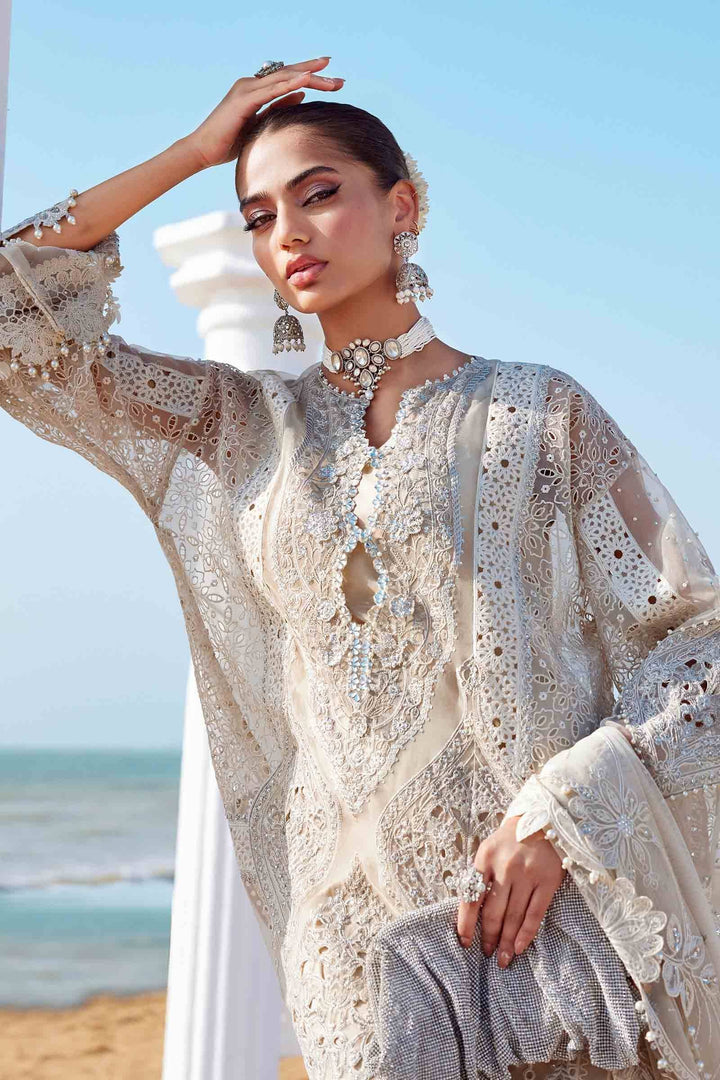 Model in AL-4287 Embroidered Suit with sheer sleeves and detailed neckline. Embellished with pearls and diamantes for a festive look.