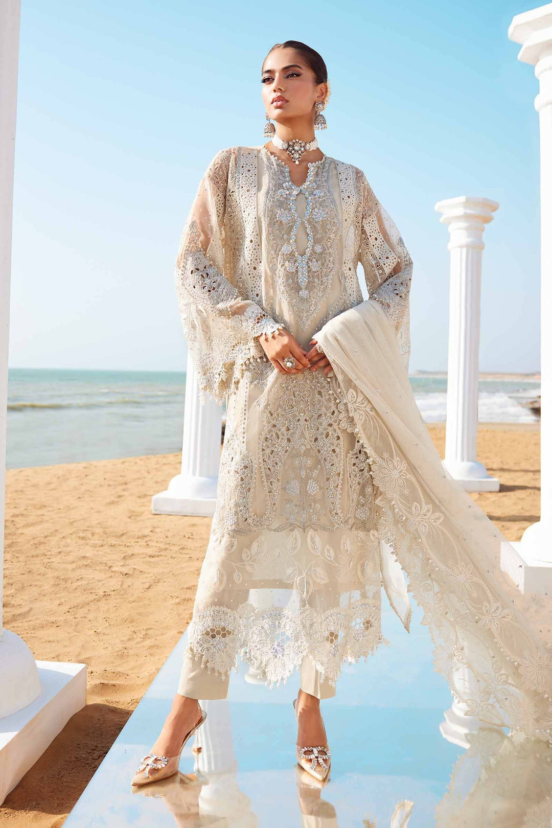 3 Piece Embroidered Suit AL-4287 with 3D flowers, pearls, and diamantes, ideal for party wear. Elegant beige outfit with dupatta on beach backdrop.