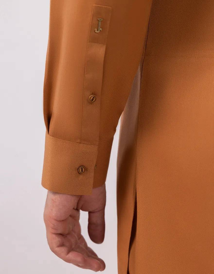 Detailed view of orange kurta collar with intricate embroidery