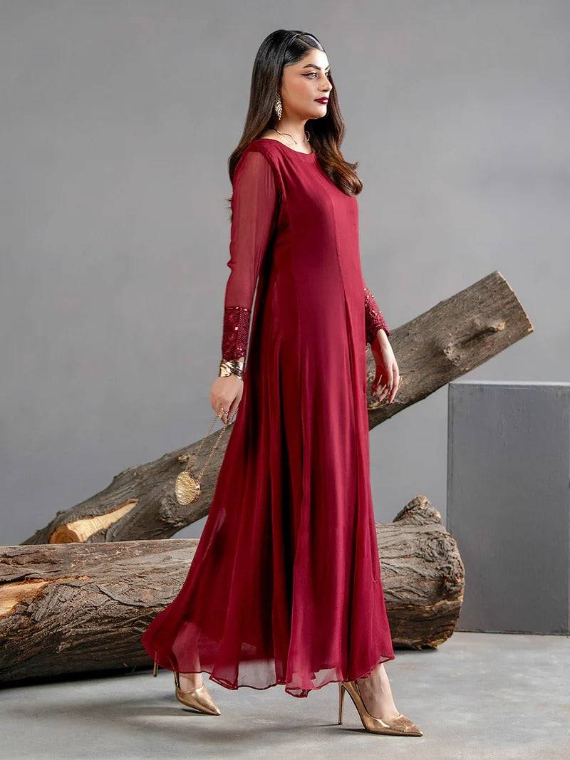Side view of maroon chiffon gown with embroidered sleeves