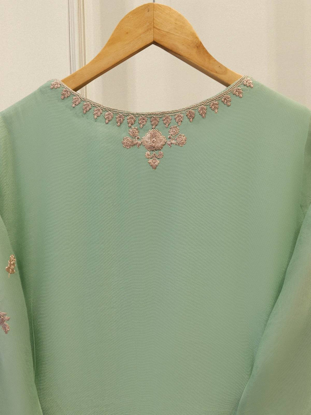 Back neckline embroidery of AGHA NOOR Cotton Suit with delicate pink floral motifs on mint green fabric, offering a refined finish.