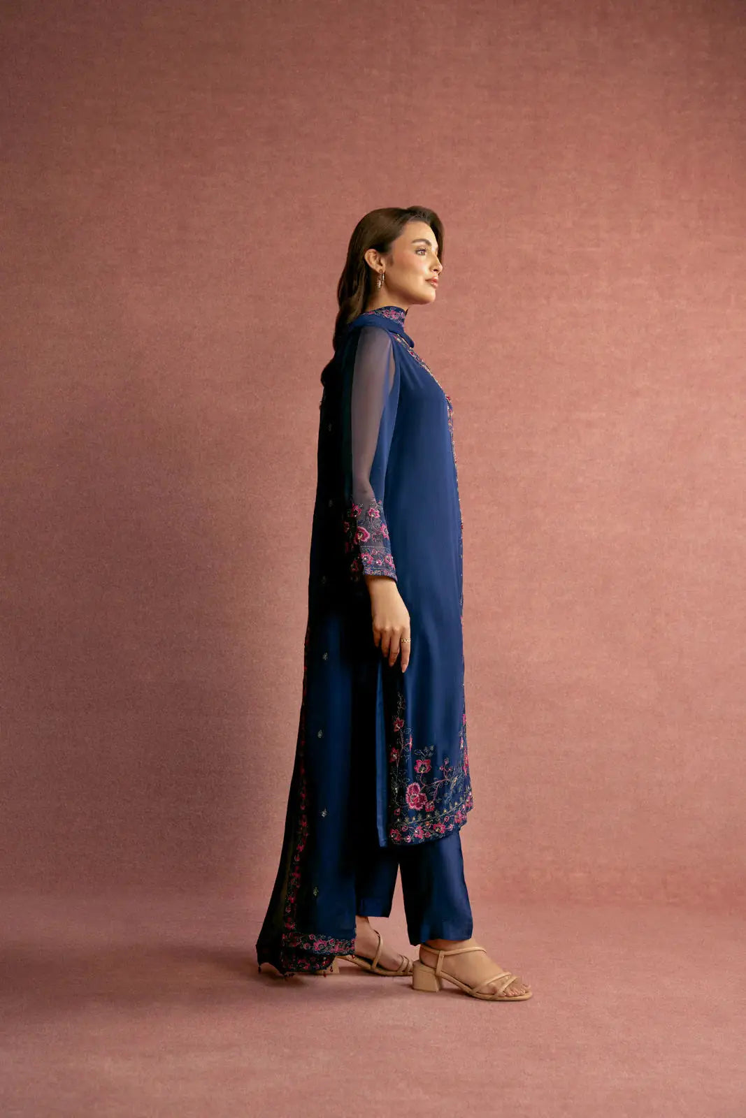 Side view of CHINYERE 3 Piece Chiffon Embroidered Suit showcasing elegant floral embroidery on sleeves and hem, ideal for festive wear.