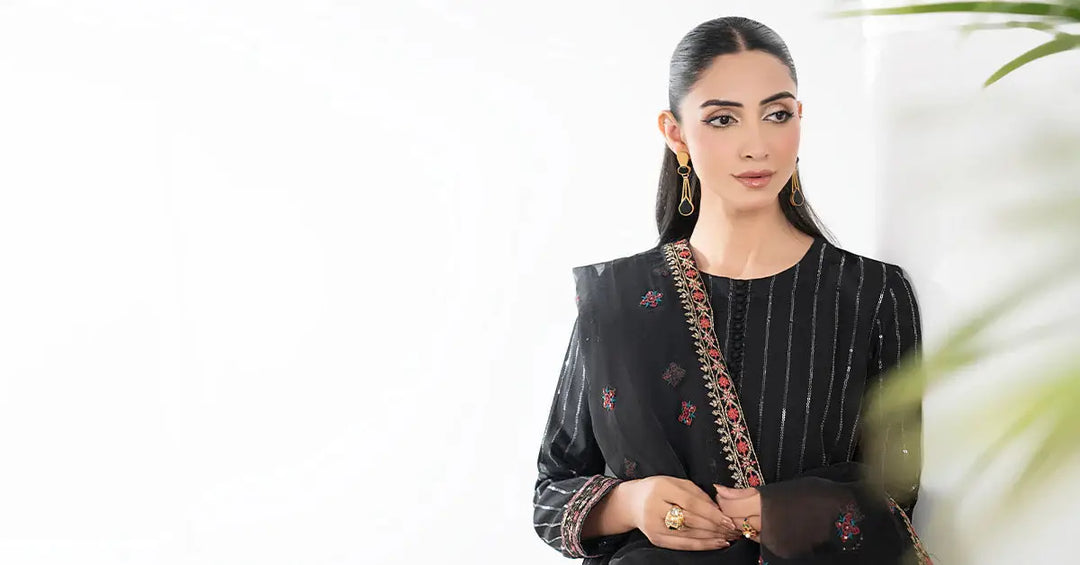 Model wearing black embroidered linen suit with dupatta