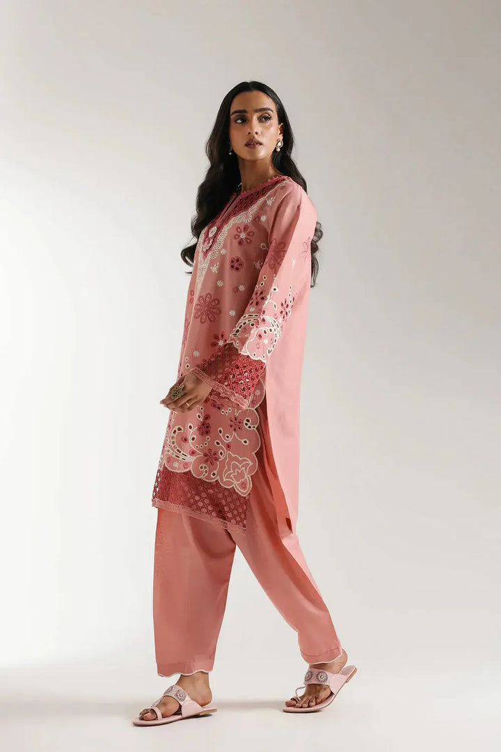 Blush coral EMBROIDERED SUIT E3120 with floral embroidery and cutwork sleeves, shown in a side walking pose for summer fashion appeal.