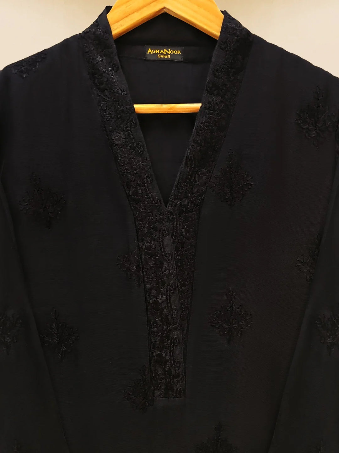 Close-up of black embroidered neckline detail