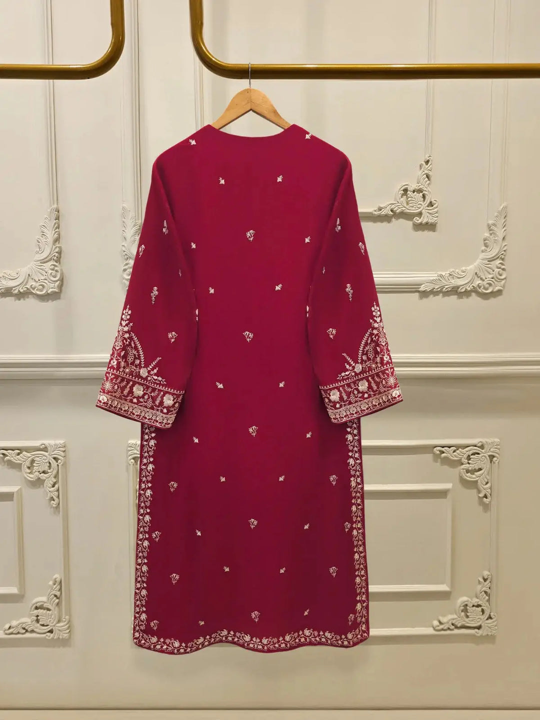Back view of AGHA NOOR 3 Piece Pure Embroidered Cotton Net Suit showcasing delicate white motifs on a deep pink shirt with embroidered sleeves and hem.