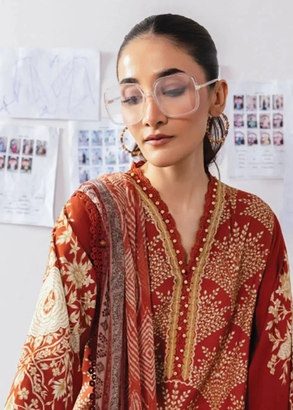 Close-up of MB-CUS25-1108-B Maria B rust orange linen shirt with intricate gold print and embroidered neckline, paired with chiffon dupatta.