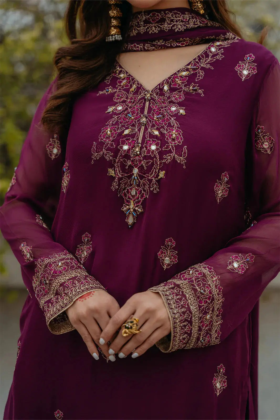 Close-up of CHINYERE Embroidered Suit neckline and sleeves, highlighting mirror, tilla, and Resham embroidery on chiffon fabric.
