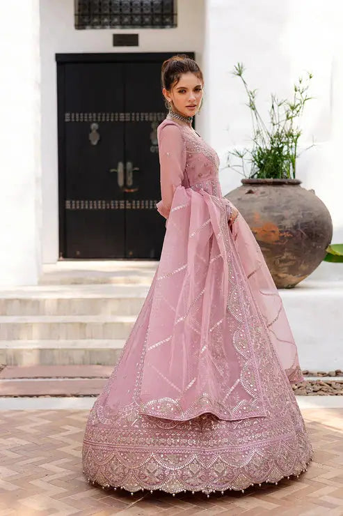 Side profile of MARYUM AND MARIA pink chiffon dress with ornate embroidery, highlighting the flared hem and elegant dupatta drape.