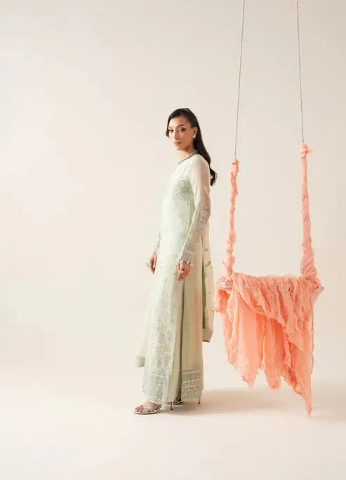 Side view of MARYUM AND MARIA Chiffon Pakistani outfit with long embroidered shirt, straight pants, and sheer dupatta for festive wear.