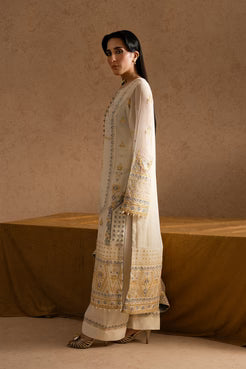 Elegant side pose showcasing MARYUM AND MARIA embroidered chiffon shirt and trouser with detailed sleeve and hem embroidery.