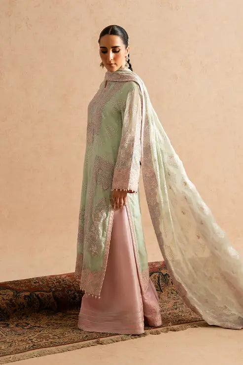 Side profile of MARYUM AND MARIA embroidered chiffon outfit with flowing dupatta and soft pastel tones, showcasing premium Pakistani dress design.
