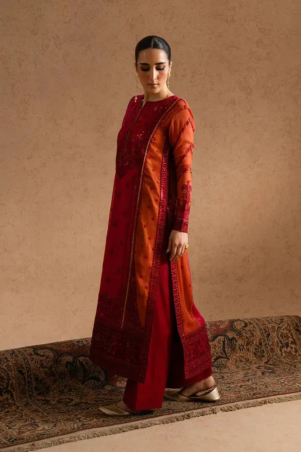 Side view of MARYUM AND MARIA embroidered chiffon formal outfit featuring rust and red shirt, matching trousers, and embellished dupatta.