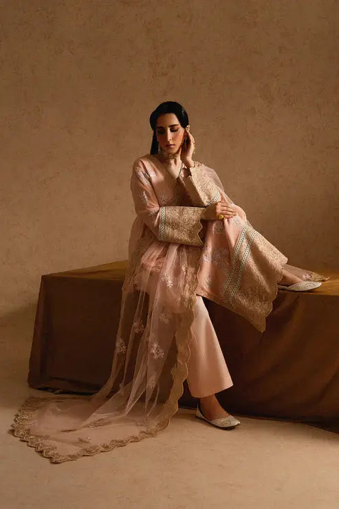 Seated model in Maryum and Maria Miray 3-piece chiffon dress with embroidered dupatta and pants, ideal for Pakistani formal events.