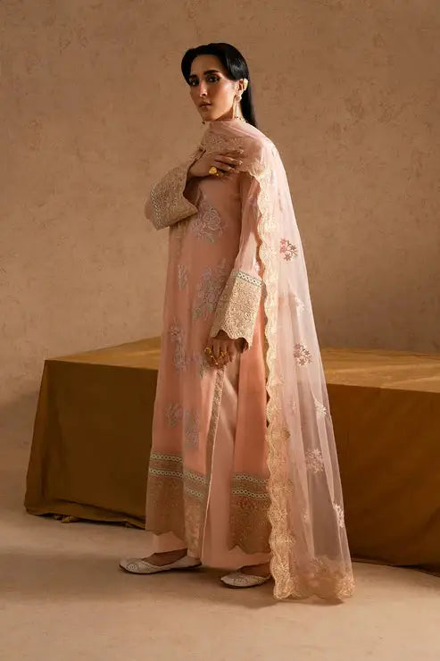 Side pose of model wearing Maryum and Maria Miray embroidered chiffon outfit with intricate sleeve and dupatta detailing for festive occasions.