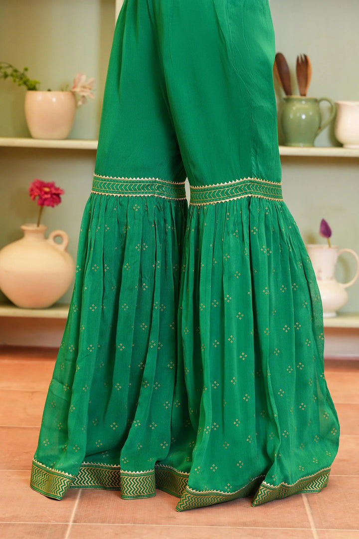 Vibrant Rang Ja Green Polka Screen Dress pant featuring pleated flare and intricate detailing, ideal for festive or casual wear.