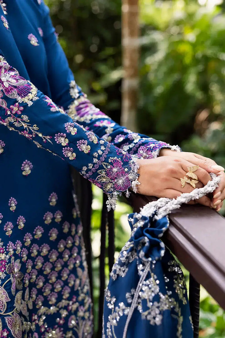 Close-up of embellished sleeve and matching drawstring bag from SAIRA RIZWAN LUXURY DELARA-SRF25-08 royal blue silk suit set.
